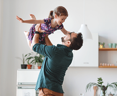 man holding child in air